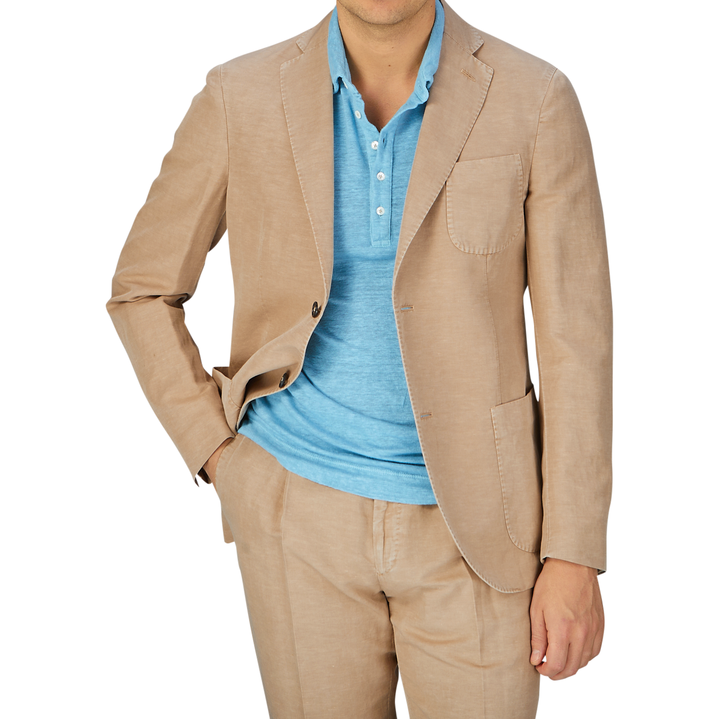 A person wearing a Slowear Light Beige Washed Chinolino Suit jacket over a light blue t-shirt, with matching medium-rise Slowear Light Beige Washed Chinolino Suit trousers.