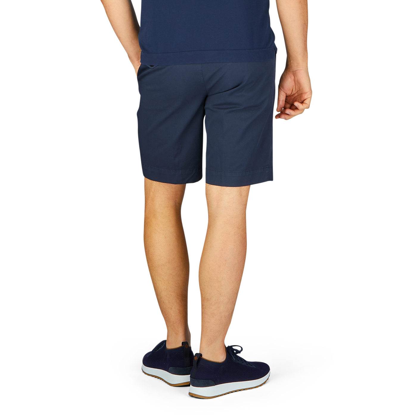 Man wearing Incotex navy blue cotton high comfort shorts and sneakers standing sideways.
