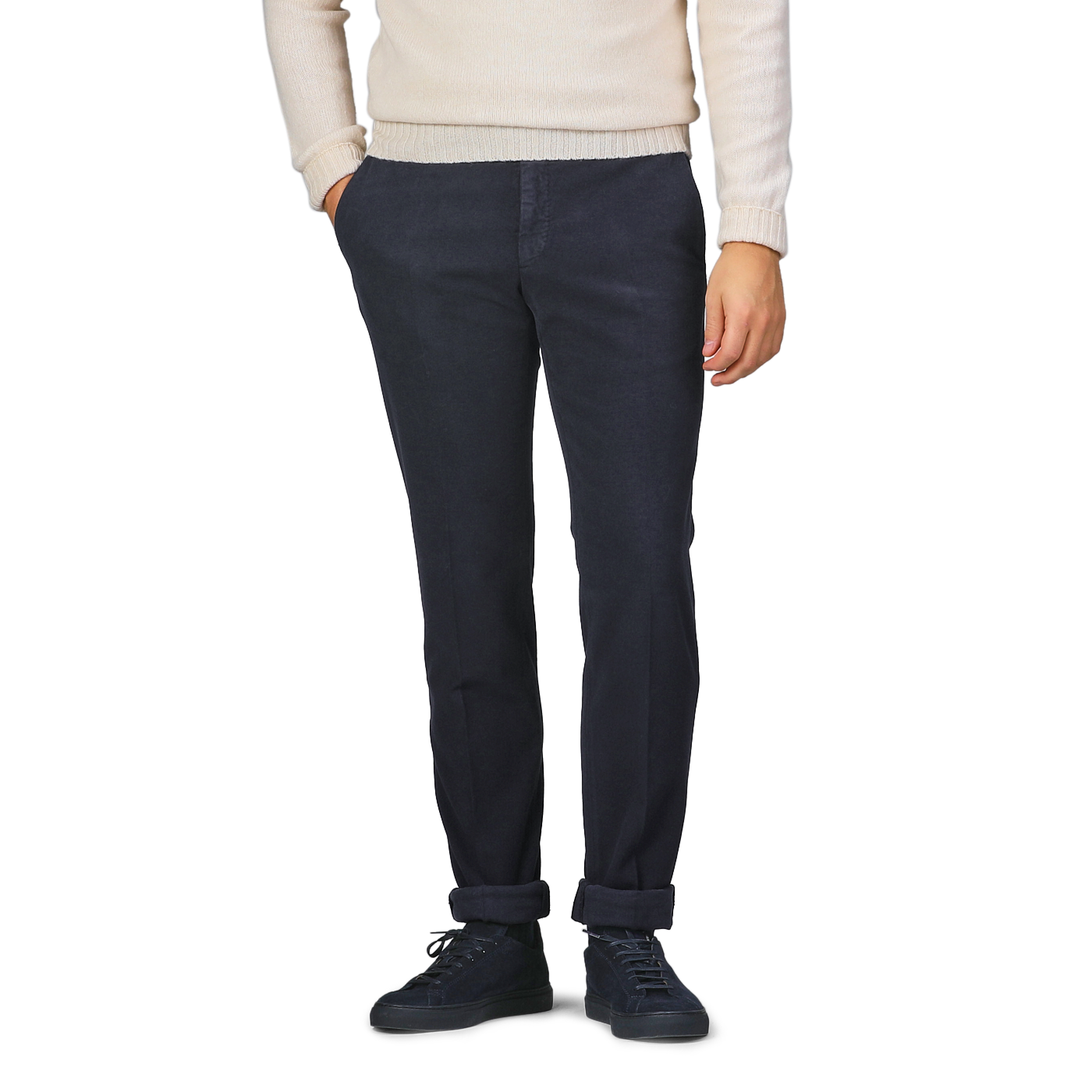 A person wearing a cream sweater, Incotex Navy Blue Cotton Moleskin Model 30 Chinos, and black sneakers stands with hands in pockets.