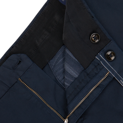 Close-up view of the waistband and fly of a pair of Incotex Navy Blue Cotton Stretch Regular Chinos, featuring a button closure, a metal zipper, and a small inner button for extra fastening.