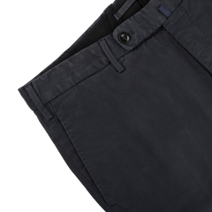 Close-up of navy blue cotton stretch chinos from Incotex's Regular Model 39 line, featuring a visible button and belt loops, displayed against a light background.