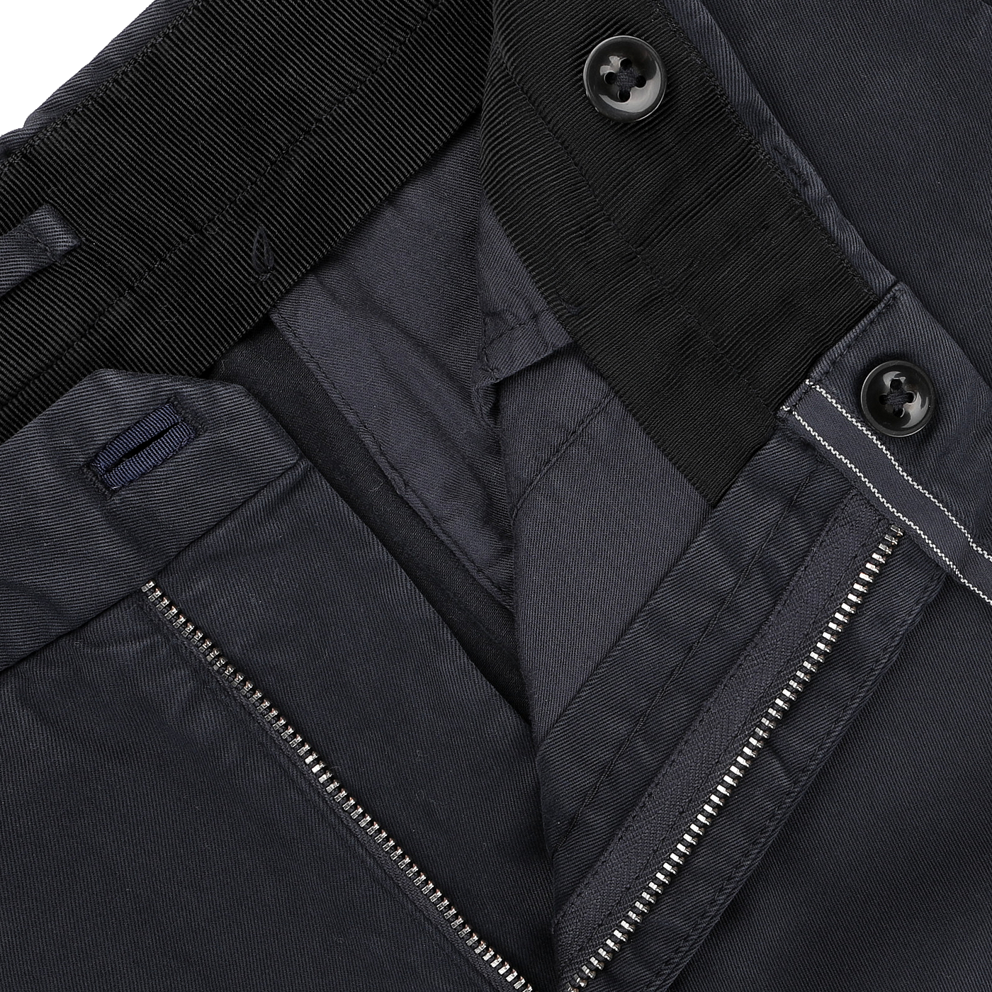 Close-up of a pair of Incotex's Navy Blue Cotton Stretch Regular Model 39 Chinos with a visible zipper and two black buttons on the waistband.