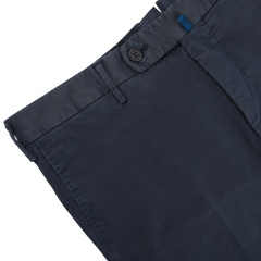 Close-up of Incotex's Navy Blue Cotton Twill Regular Chinos, showcasing button and belt loop details, set against a light gray background.