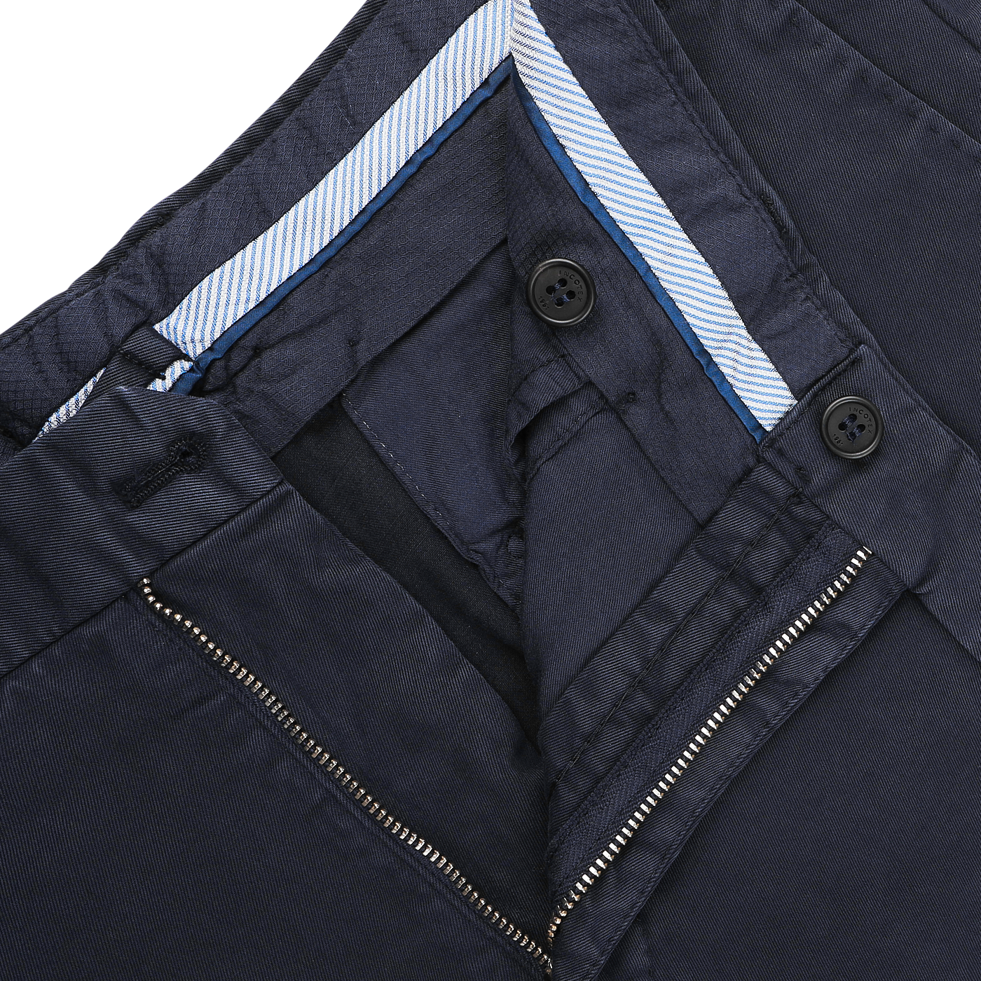 Close-up of navy blue cotton twill regular chinos by Incotex, highlighting the waistband, zipper, and two sleek buttons.