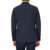 Rear view of a man wearing a Slowear navy blue washed Chinolino suit jacket.