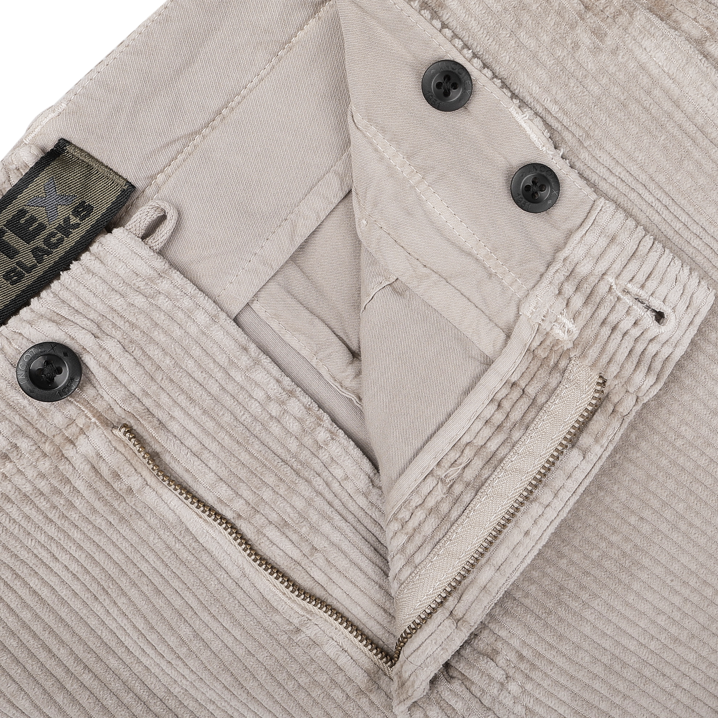 Close-up of Incotex Taupe Beige Cotton Corduroy Regular Fit Trousers, medium rise, partially unzipped with visible button fly and tag.