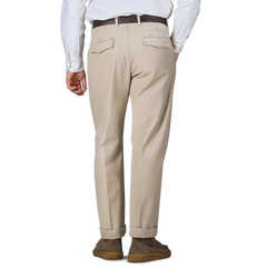 A person wearing a white shirt and Incotex Washed Beige Single Pleat Cotton Slacks with a brown belt, viewed from behind.