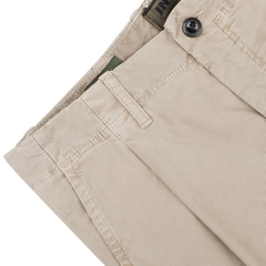 Close-up of the Washed Beige Single Pleat Cotton Slacks by Incotex featuring a buttoned waistband and belt loops.