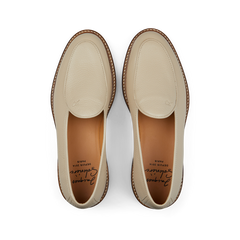 A pair of Beige Grained Leather Lex loafers by Jacques Soloviére Paris, with stitching details, displayed from a top-down perspective on a black background.