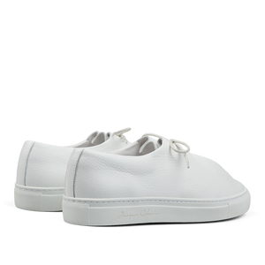 A pair of White Grained Leather Jim Sneakers, Jacques Soloviére Paris lace-up sneakers with a minimalist design on a transparent background.