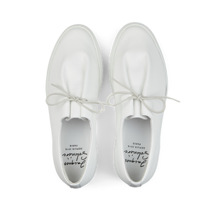 A pair of contemporary Jacques Soloviére Paris Jim sneakers crafted from white grained leather, featuring slip-on design with laces, displayed against a white background.