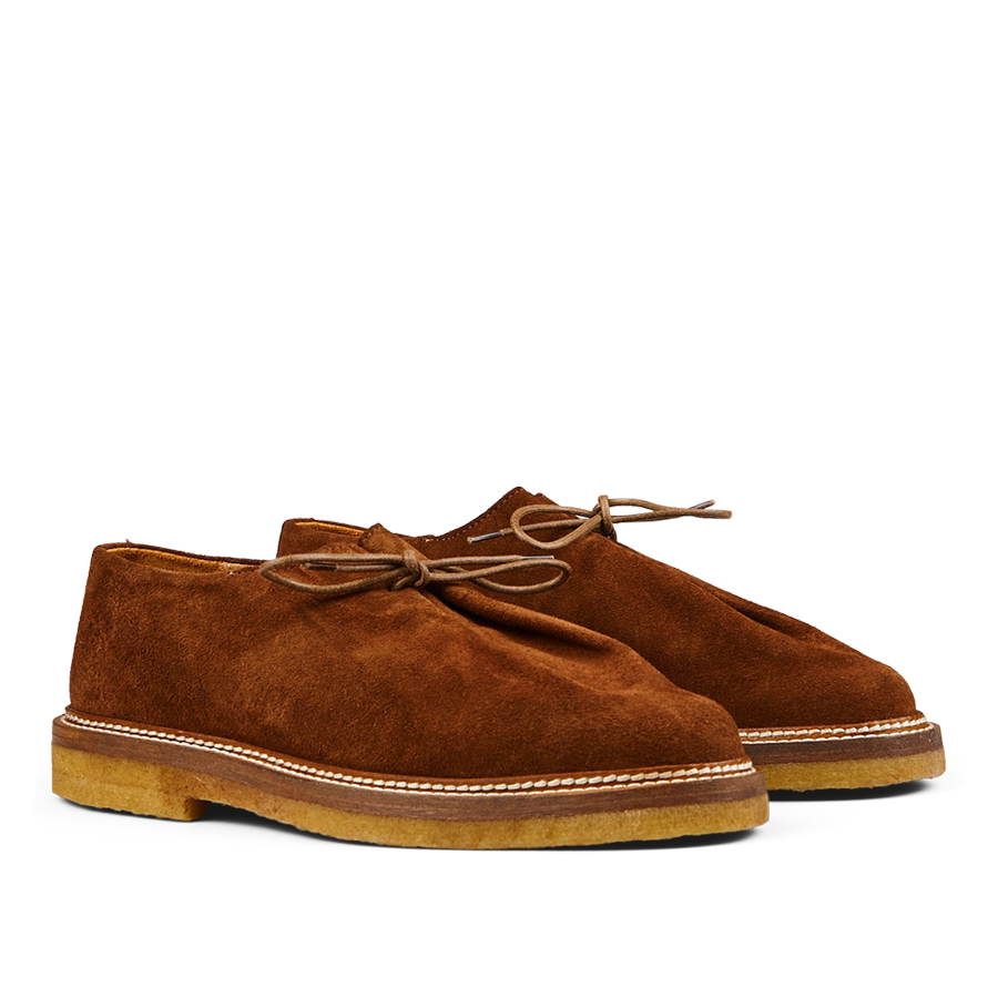 A pair of timeless Tobacco Brown Suede Leather Ray Derbies men's desert boots with laces on a plain background by Jacques Soloviére Paris.