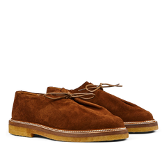 A pair of timeless Tobacco Brown Suede Leather Ray Derbies men's desert boots with laces on a plain background by Jacques Soloviére Paris.