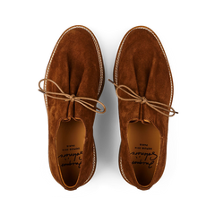 A pair of Tobacco Brown Suede Leather Ray Derbies from Jacques Soloviére Paris, with laces, viewed from above, against a black background.