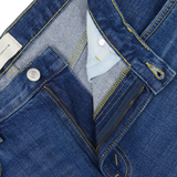 Close-up of a blue Jeanerica denim jacket with detailed stitching and a light blue shirt collar underneath, featuring the Medium Blue Washed Cotton TM005 Jeans.