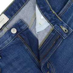 Close-up of a blue Jeanerica denim jacket with detailed stitching and a light blue shirt collar underneath, featuring the Medium Blue Washed Cotton TM005 Jeans.