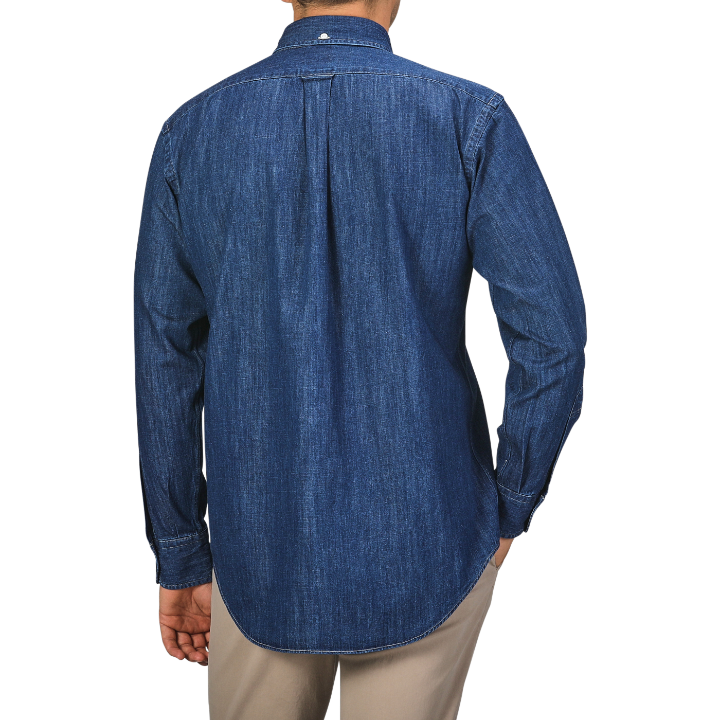 A person stands facing away, wearing a Kamakura Shirts Dark Blue Japanese Denim 7oz BD Shirt with a button-down collar and beige pants.