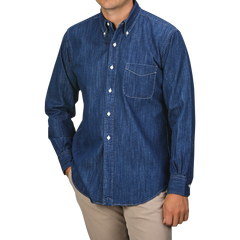 A person wearing a Kamakura Shirts Dark Blue Japanese Denim 7oz BD Shirt, featuring a button-down collar and front pocket, paired with beige pants. The person's face is not visible.