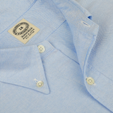 Close-up of a Light Blue Washed Cotton Oxford BD Shirt from Kamakura Shirts, featuring a 16-inch neck size label and made in the USA. The pure cotton oxford fabric is showcased along with the shirt's collar and buttons in detail.