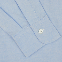 Close-up of a Light Blue Washed Cotton Oxford BD Shirt sleeve from Kamakura Shirts, featuring a buttoned cuff. The pure cotton oxford fabric has a fine, textured pattern.