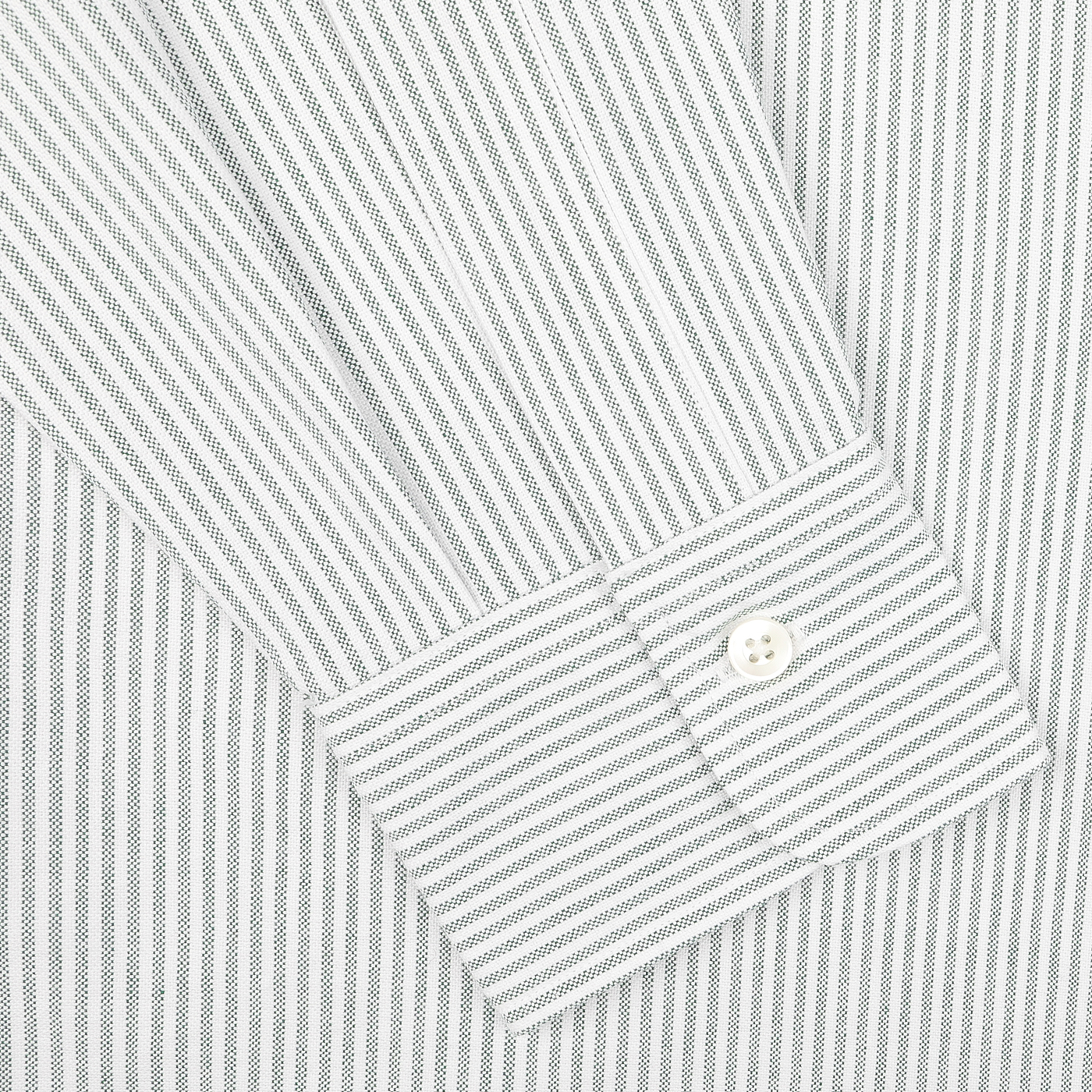 Close-up of a sleeve and cuff from Kamakura Shirts' Green Striped Washed Cotton Oxford BD Shirt, featuring a single white button. Crafted from pure cotton oxford, this piece embodies timeless elegance.