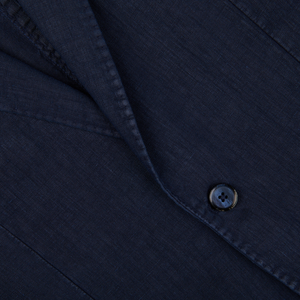 Close-up of a L.B.M. 1911 navy blue washed linen suit jacket with detailed stitching and a visible button.