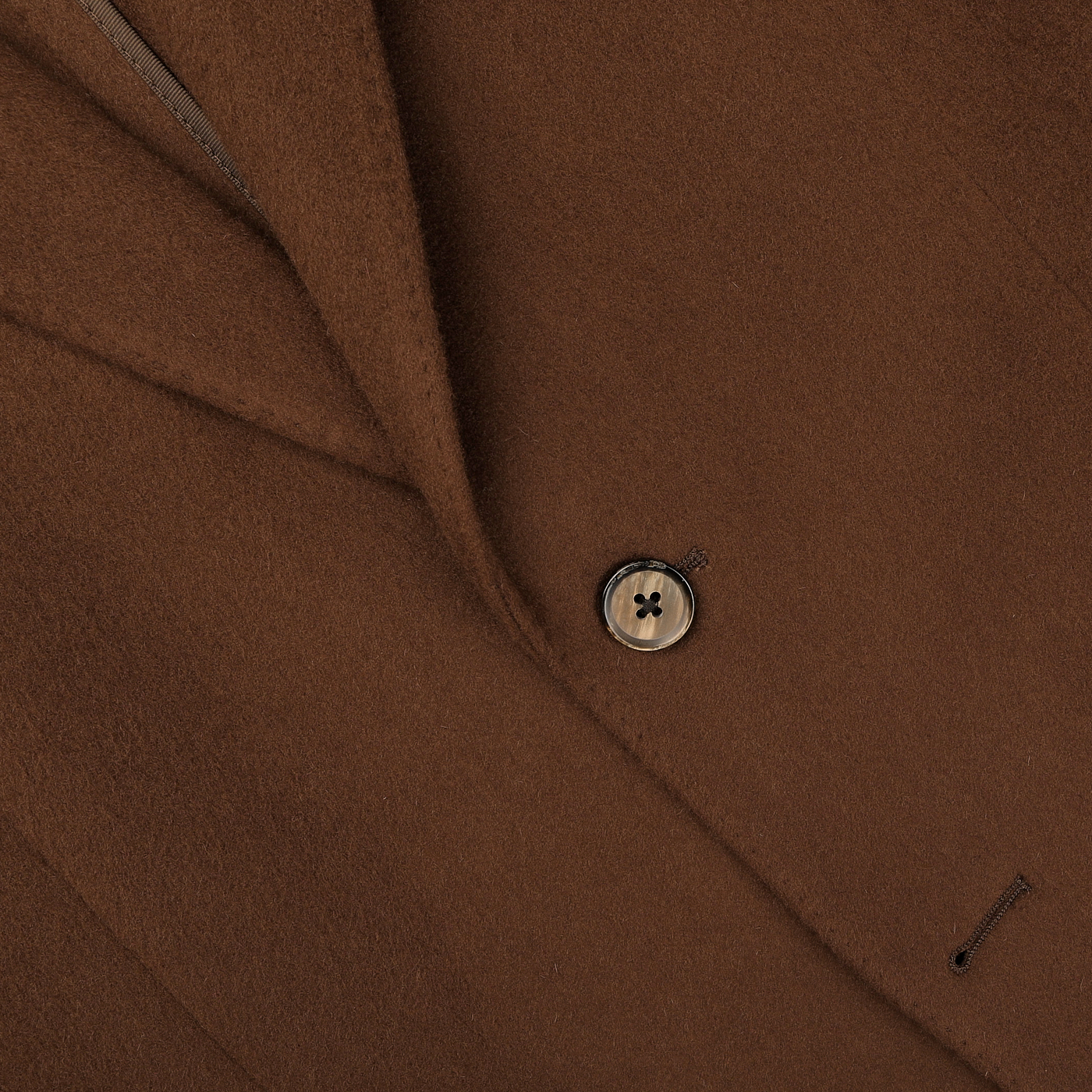 A close-up of the L.B.M. 1911 Tobacco Brown Brushed Wool Slim Blazer highlights its pure virgin wool fabric and single-button fastening.