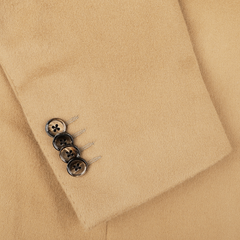 Close-up of the Camel Beige Brushed Wool Slim Blazer sleeve by L.B.M. 1911, crafted from pure virgin wool and adorned with four dark buttons in a linear arrangement.