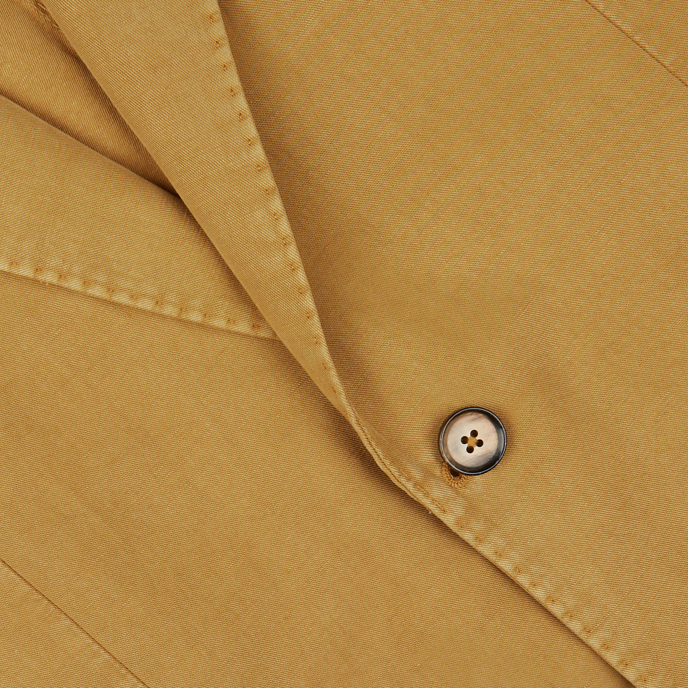 Close-up of a button on a Dark Beige Washed Cotton Linen Blazer from L.B.M. 1911 with visible stitching.