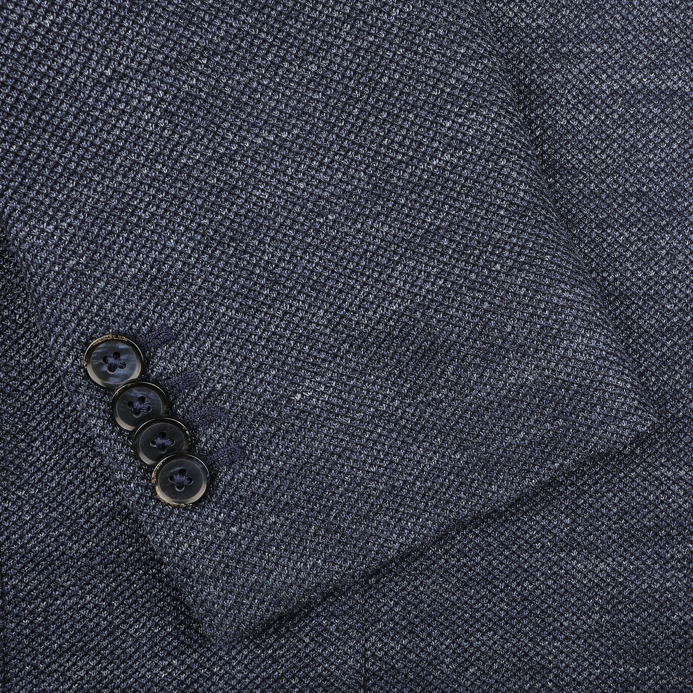 Close-up of a slim fit L.B.M. 1911 Dark Blue Linen Cotton Jersey Blazer sleeve, showcasing a sophisticated texture and four sleek black buttons.