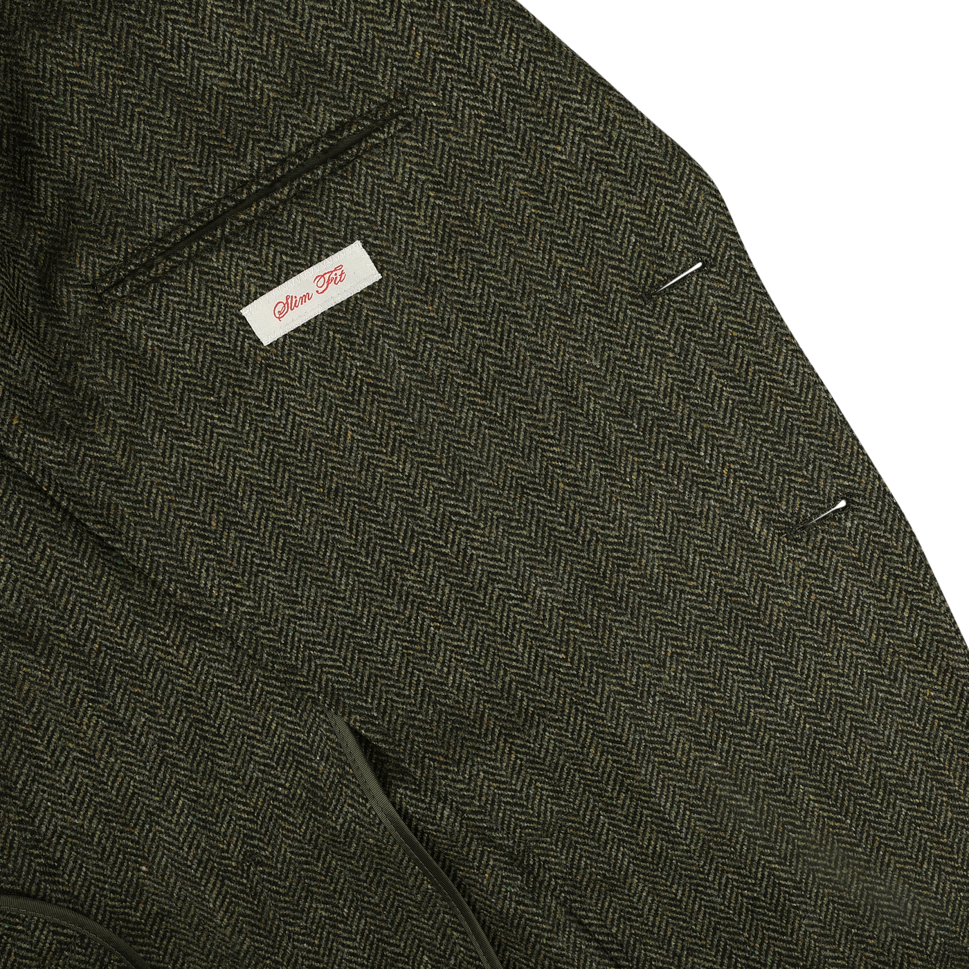 Close-up of a Dark Green Wool Cashmere Herringbone Blazer by L.B.M. 1911, featuring a labeled chest pocket with "Allen Flusser" visible on the inside tag.