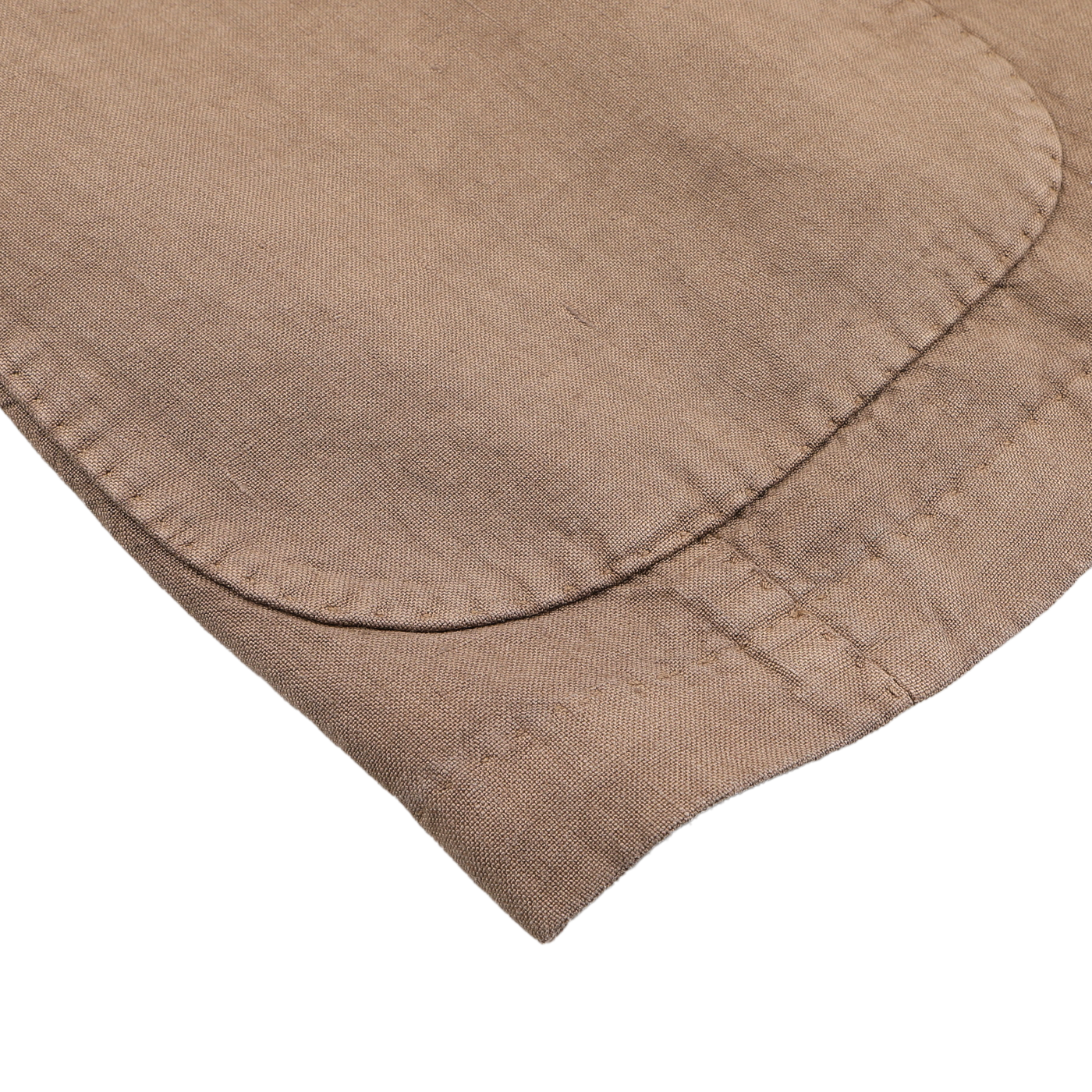 A close-up of a light brown fabric sleeve with visible seam and stitching, echoing the exquisite craftsmanship from L.B.M. 1911's Light Brown Washed Linen Blazer, elegantly set on a white surface.