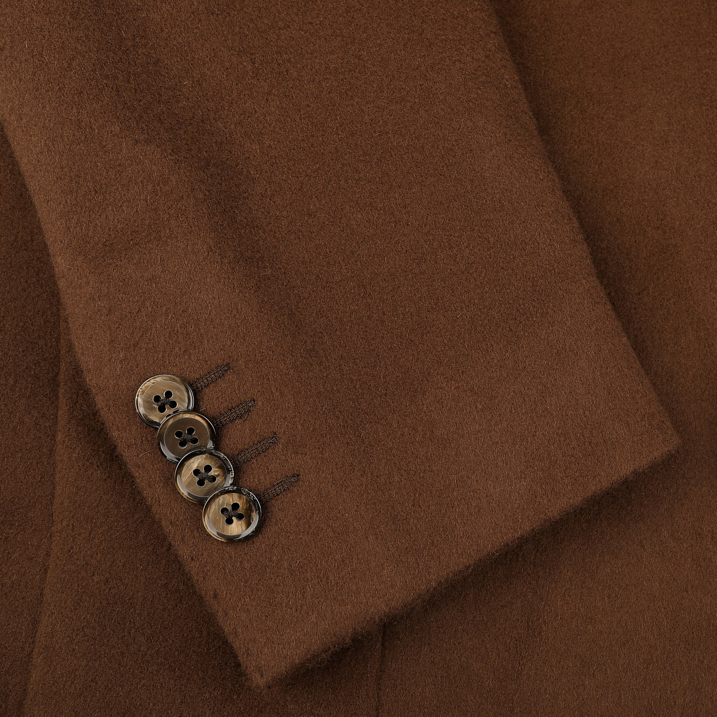 A close-up of the L.B.M. 1911 Tobacco Brown Brushed Wool Slim Blazer sleeve highlights four intricately stitched buttons on the cuff, crafted from pure virgin wool.