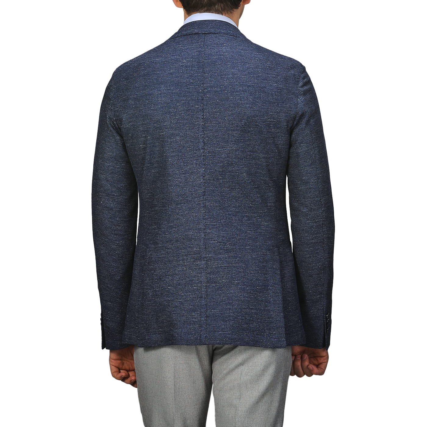 Rear view of a person in an L.B.M. 1911 Dark Blue Linen Cotton Jersey Blazer and light gray pants, set against a plain gray background.