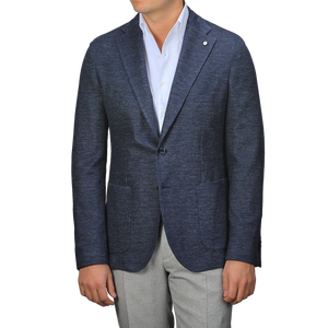 A person dons an L.B.M. 1911 Dark Blue Linen Cotton Jersey Blazer over a white shirt and gray pants, with no visible face.