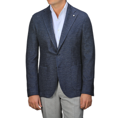 A person dons an L.B.M. 1911 Dark Blue Linen Cotton Jersey Blazer over a white shirt and gray pants, with no visible face.