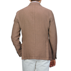 A person is seen from the back wearing a slim fit L.B.M. 1911 Light Brown Washed Linen Blazer with white pants against a plain background.