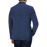 A man seen from the back wearing a Navy Blue Washed Cotton Linen Blazer and jeans, both reflecting exquisite Italian tailoring by L.B.M. 1911.