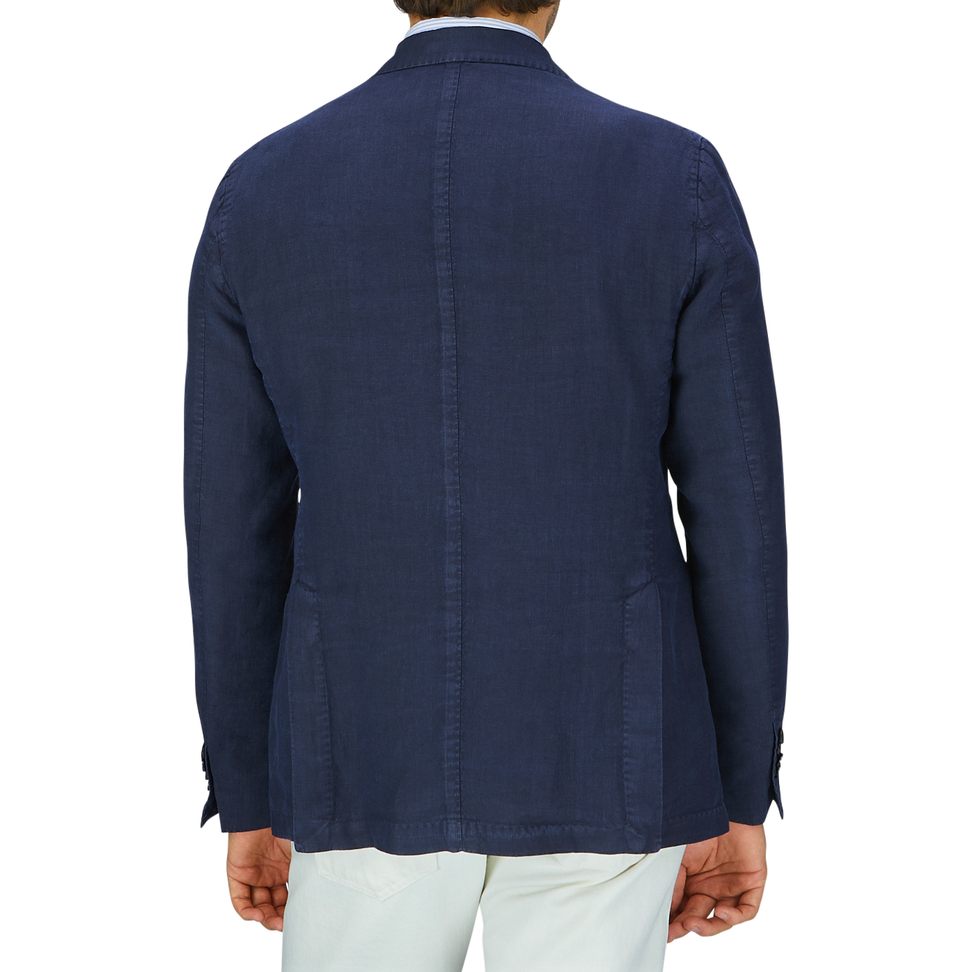 Rear view of a man wearing a tailored L.B.M. 1911 navy blue washed linen blazer and light-colored linen trousers.