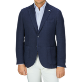 Man wearing a L.B.M. 1911 Navy Blue Washed Linen Blazer and white pants.