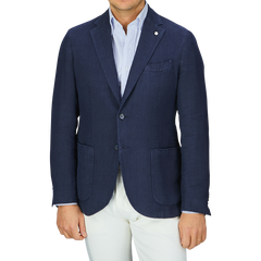 Man wearing a L.B.M. 1911 Navy Blue Washed Linen Blazer and white pants.