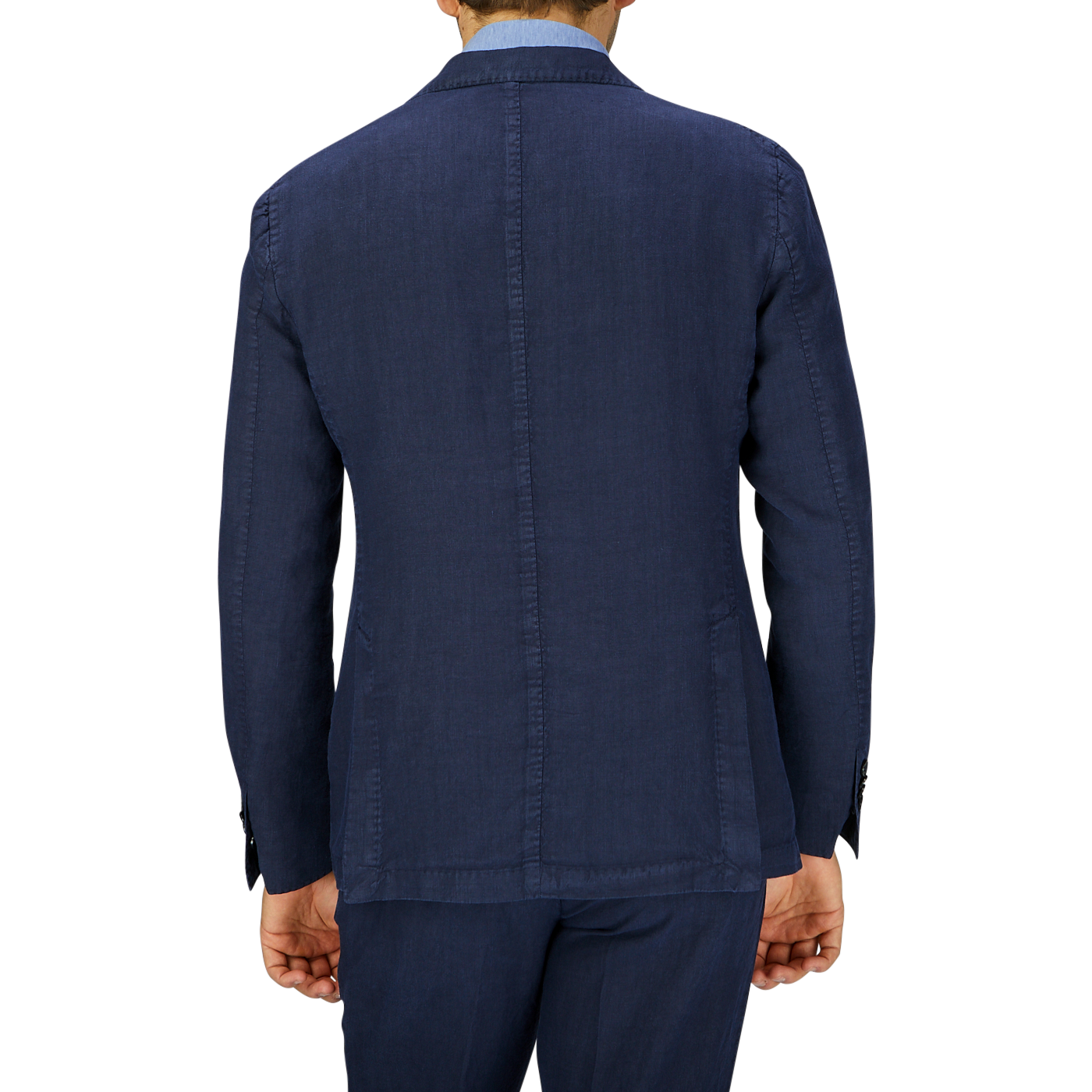A man viewed from the back, wearing a dark navy blue, unbuttoned L.B.M. 1911 washed linen suit jacket and matching trousers.
