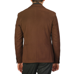 A man is seen from the back, wearing an L.B.M. 1911 Tobacco Brown Brushed Wool Slim Blazer paired with dark pants.