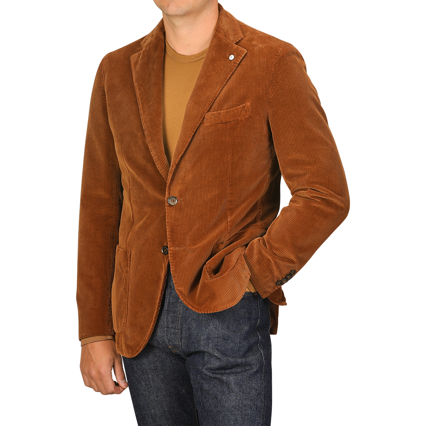 A person wearing an L.B.M. 1911 Cinnamon Brown Cotton Corduroy Blazer, a brown t-shirt, and dark blue jeans, with one hand in their pocket. The person’s face is not visible.