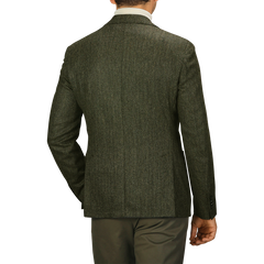 A man is shown from the back wearing an L.B.M. 1911 Dark Green Wool Cashmere Herringbone Blazer, in a slim fit, paired with khaki pants.