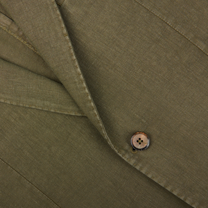 Close-up of a Grass Green Washed Linen Blazer with a button, likely part of an L.B.M. 1911 blazer.