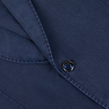 Close-up of a Navy Blue Washed Cotton Linen Blazer fabric with a button, likely showcasing exquisite Italian tailoring by L.B.M. 1911.