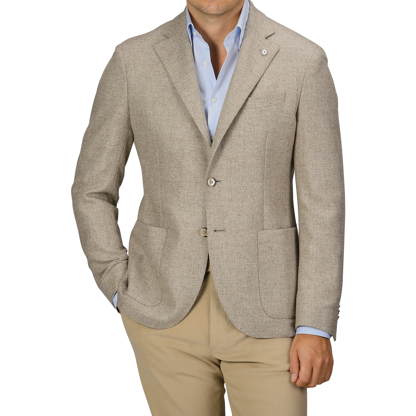 A man wearing an Oatmel Beige Shetland Wool Cashmere Blazer by L.B.M. 1911, paired with a light blue dress shirt and beige pants, stands with his hands in his pockets. The slim fit, seasonal blazer features two buttons and patch pockets.