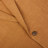 Close-up of a brown button on a L.B.M. 1911 Tobacco Brown Washed Linen Blazer.