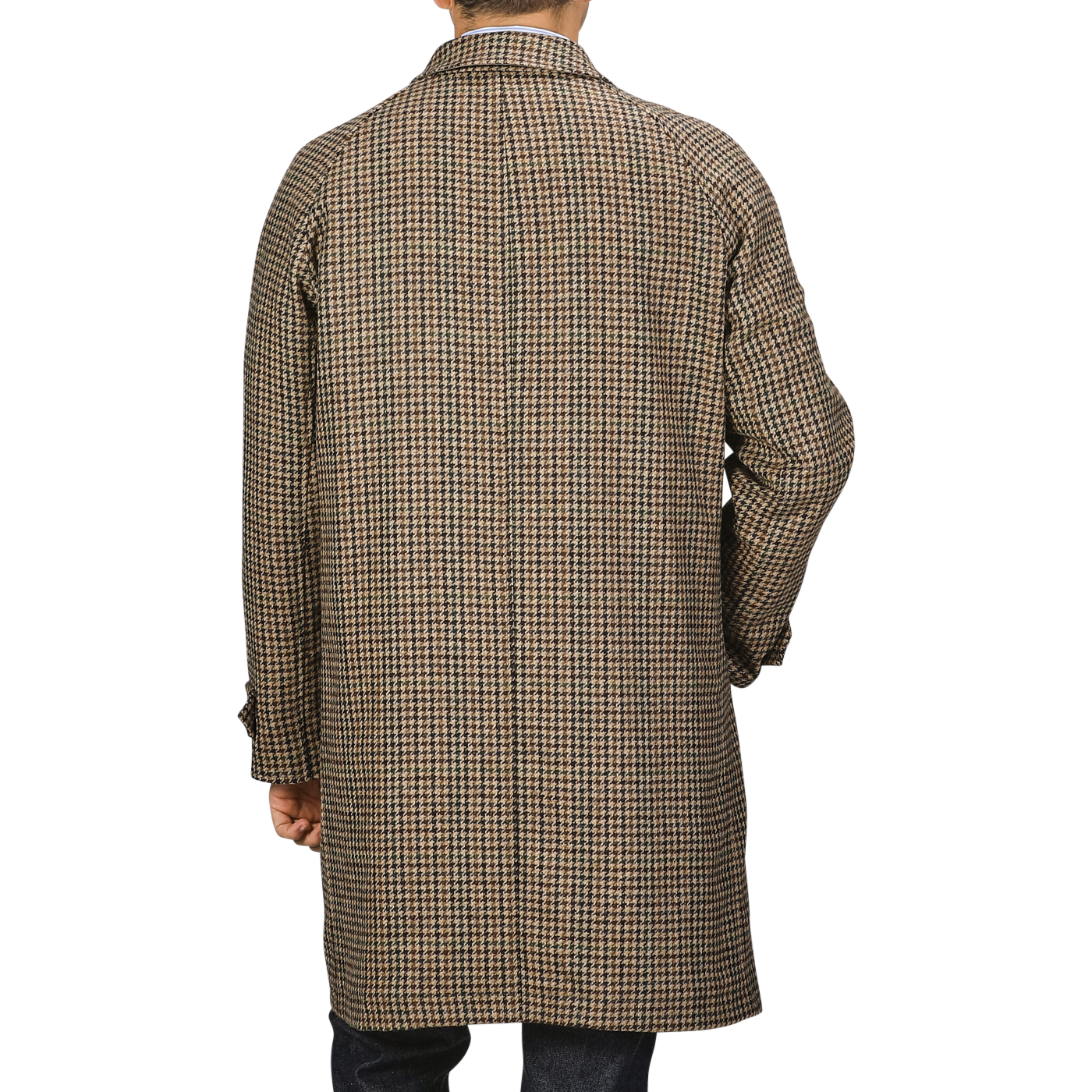 A person is facing away, draped in a long Beige Houndstooth Wool Tweed Reversible Coat by L'Impermeabile, with their hands by their sides. The background is gray.